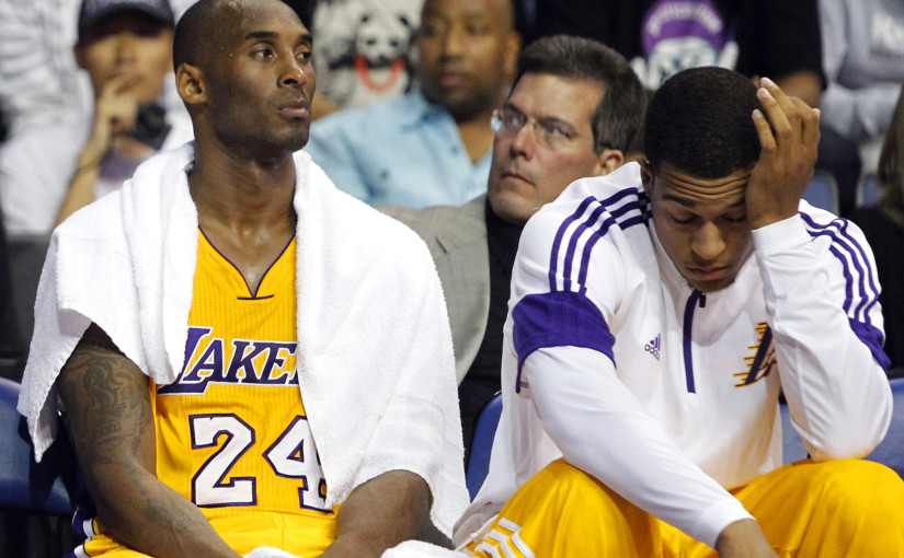 Los Angeles Lakers guard Kobe Bryant (24) and guard Jabari Brown, right, lament on the bench during the Golden State Warriors 116-75 win during the second half of a preseason NBA basketball game, Sunday, Oct. 12, 2014, in Ontario, Calif. (AP Photo/Alex Gallardo)